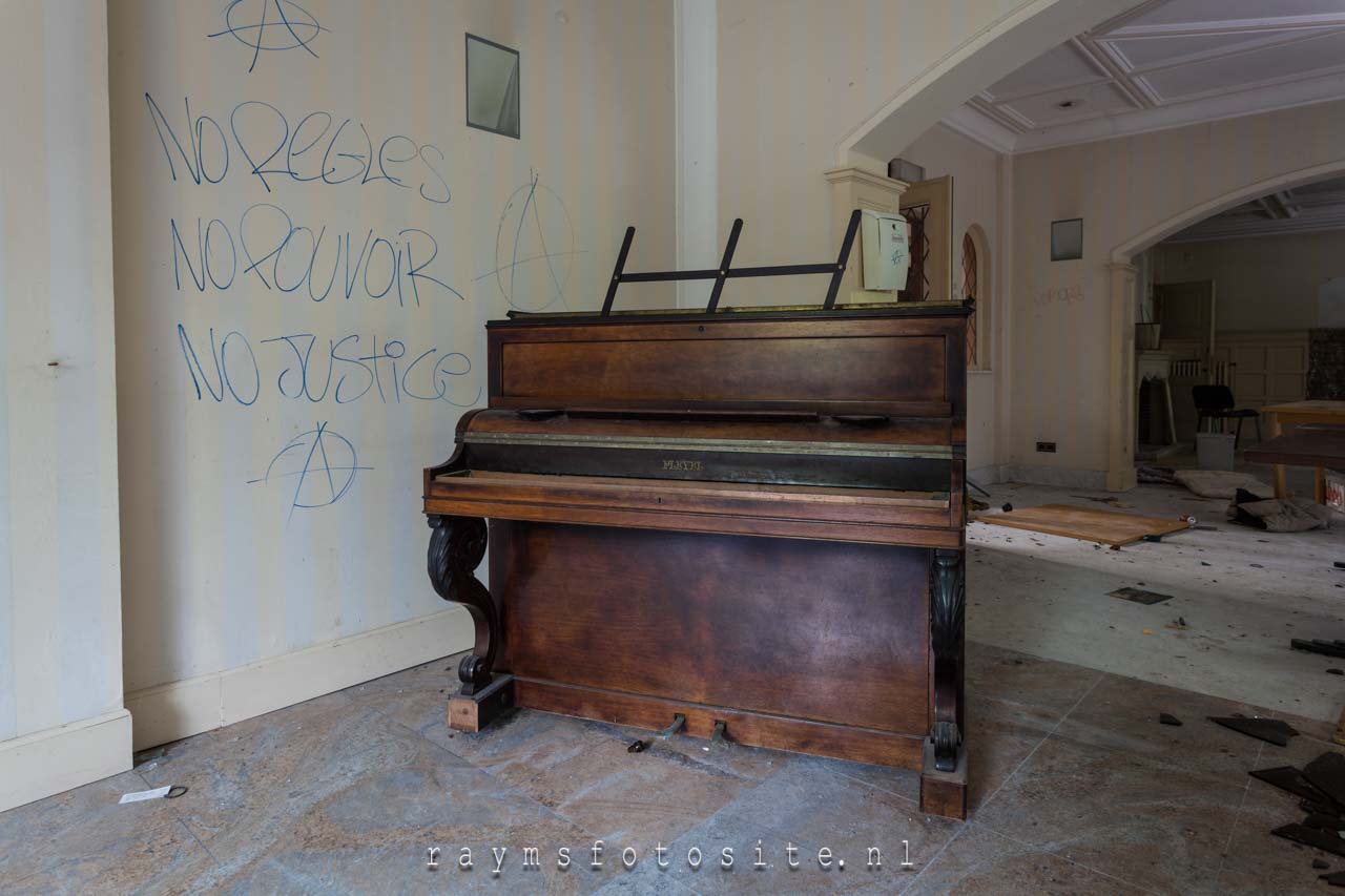 Een oude piano of wat er van over is in deze urbexlocatie